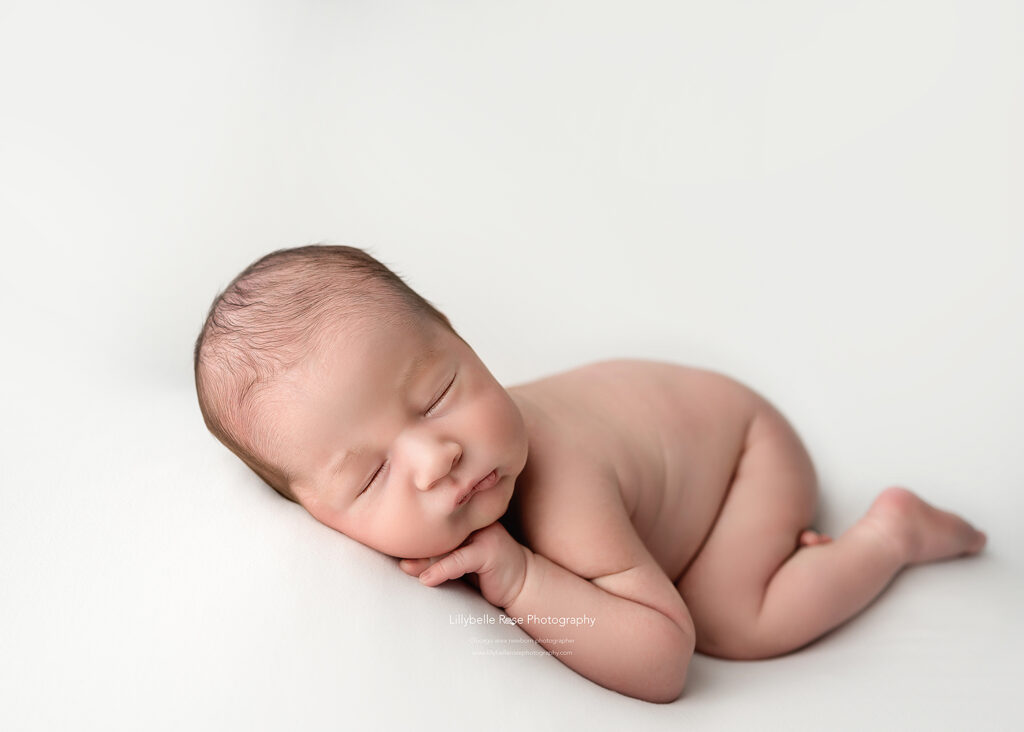 sleeping baby boy posed on white in studio session