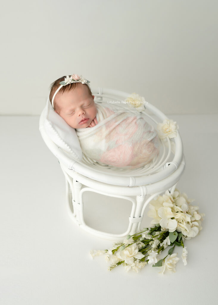 newborn sleeping in chair prop, newborn photography studio, baby photos on cream