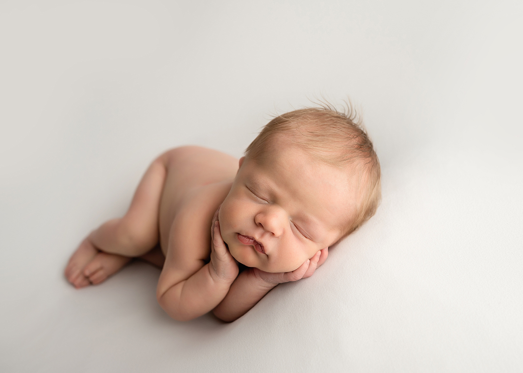 sleeping baby boy posed In newborn photoshoot