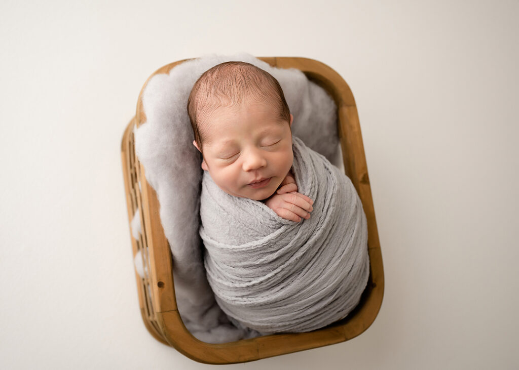 baby photoshoots of newborn in basket