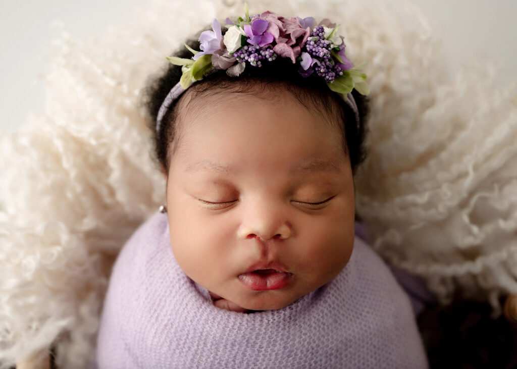 prevent-allergies-baby-child, baby girl in purple wrap with floral headband