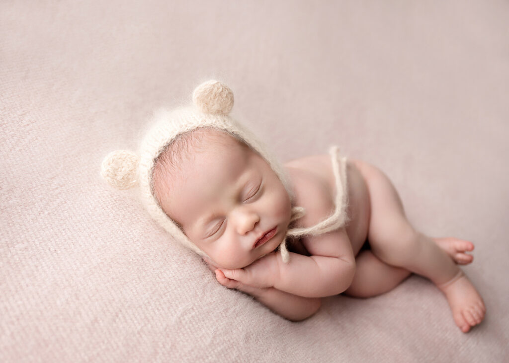 sleepy baby girl with teddy bonnet