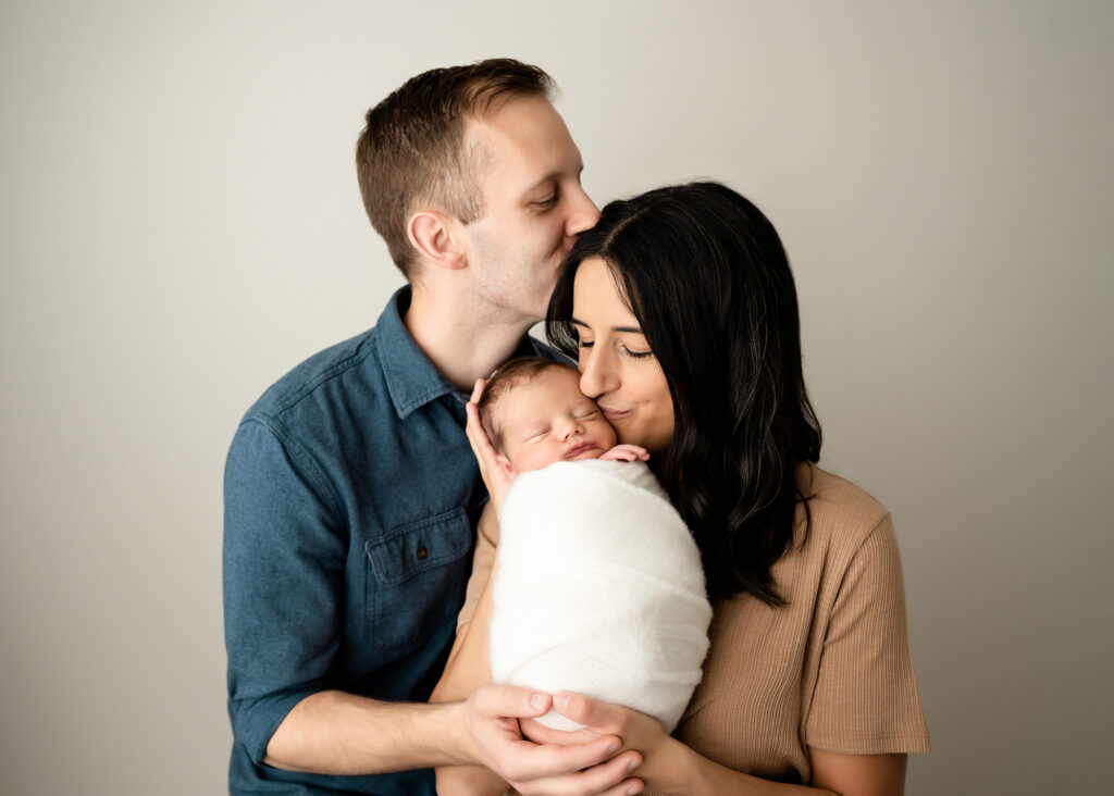 new parents snuggling baby boy, prenatal-genetic-testing