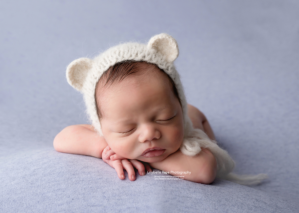 Cute teddy bear bonnet on a newborn baby boy